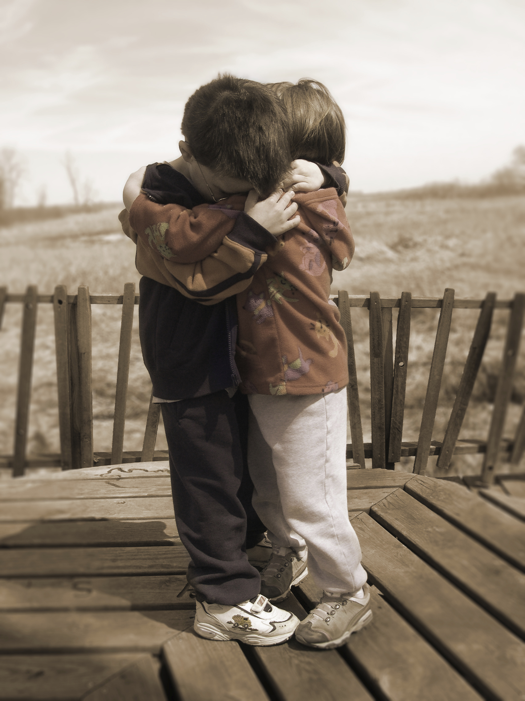 brother and sister hugging at orphanage